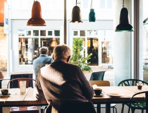 Man with Alzheimer's disease sitting in cafe