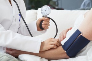 Doctor taking patient's blood pressure