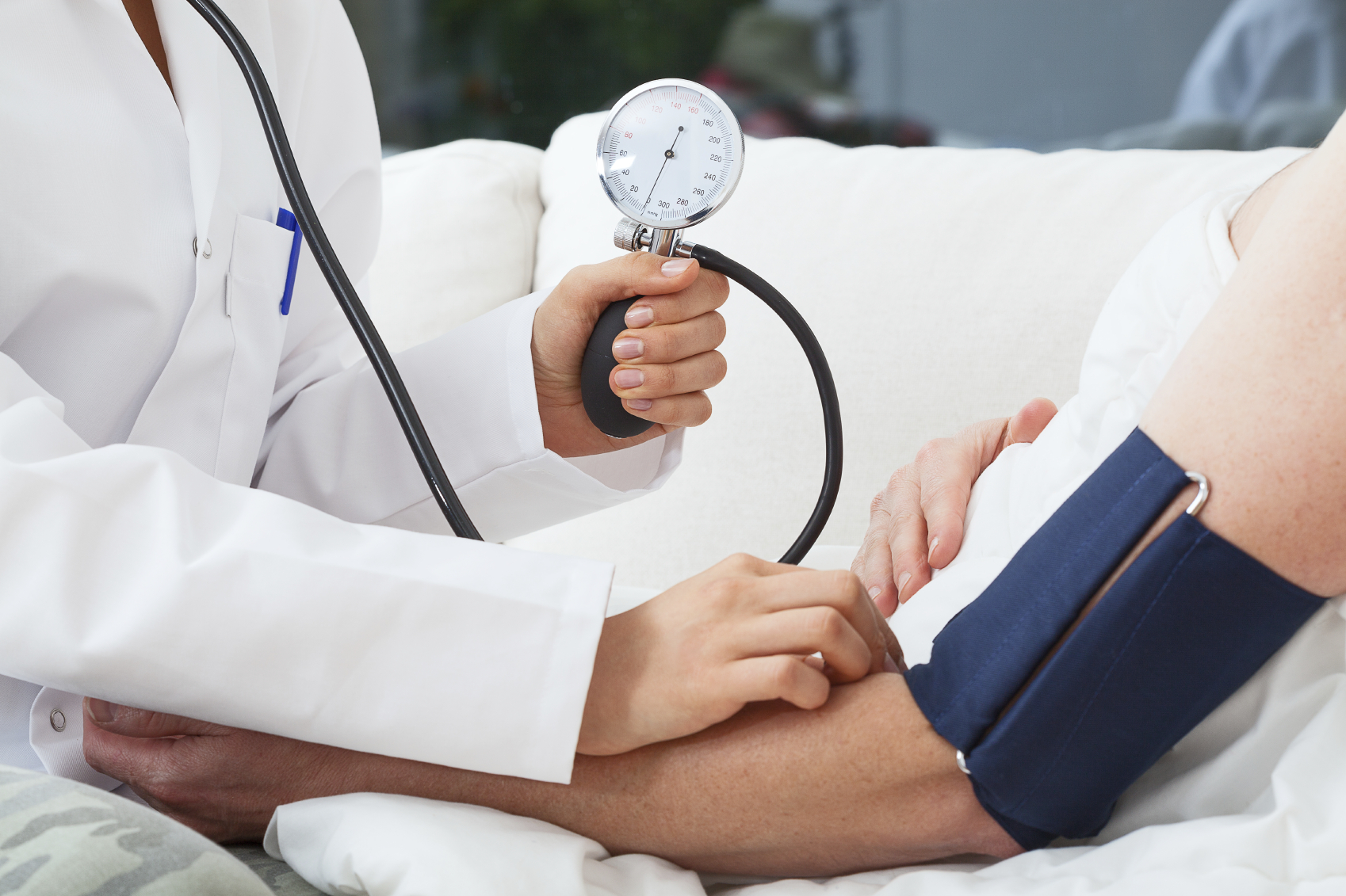 Doctor taking blood pressure of a patient