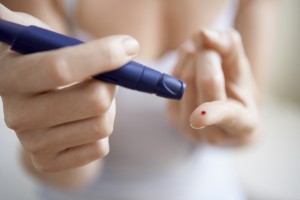 Diabetic patient measuring her blood glucose levels