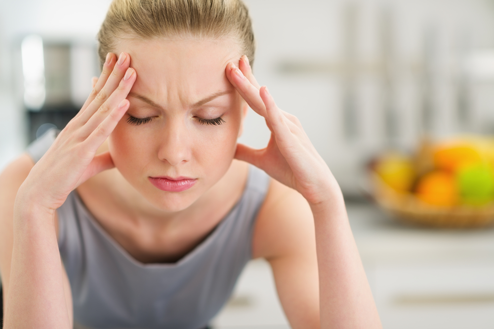 Woman suffering an intense migraine attack