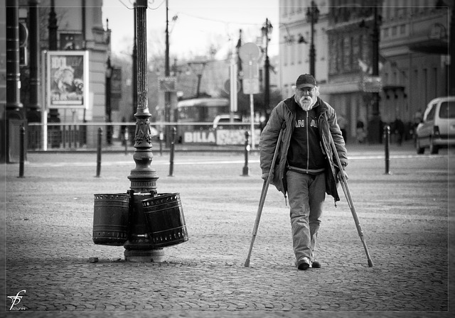 Arthritic man using crutches not to fall