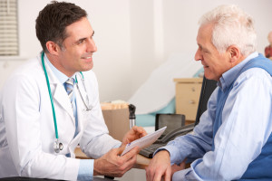 Doctor discusses prostate cancer clinical trials with older man