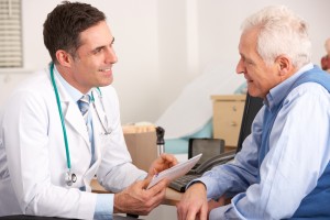 Doctor discussing arthritis complications with older patient