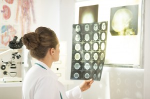 Washington oncologist looking at MRI scans