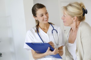 Woman with postmenopausal syndrome speaks with nurse