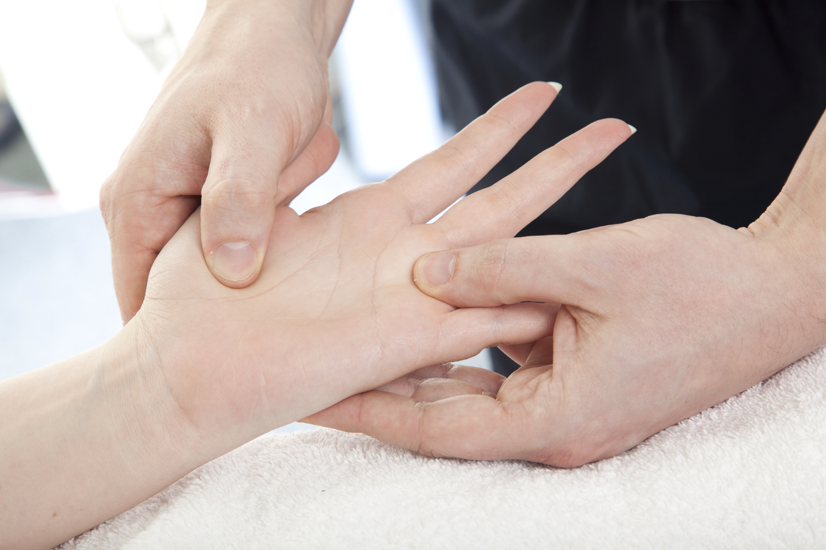 Doctor checking finger joints for rheumatoid arthritis